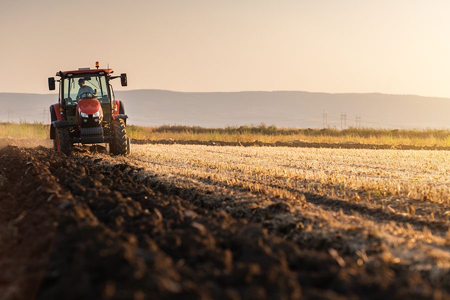 Insurance Quote - View of Farm Tractor Planting New Crops in Field